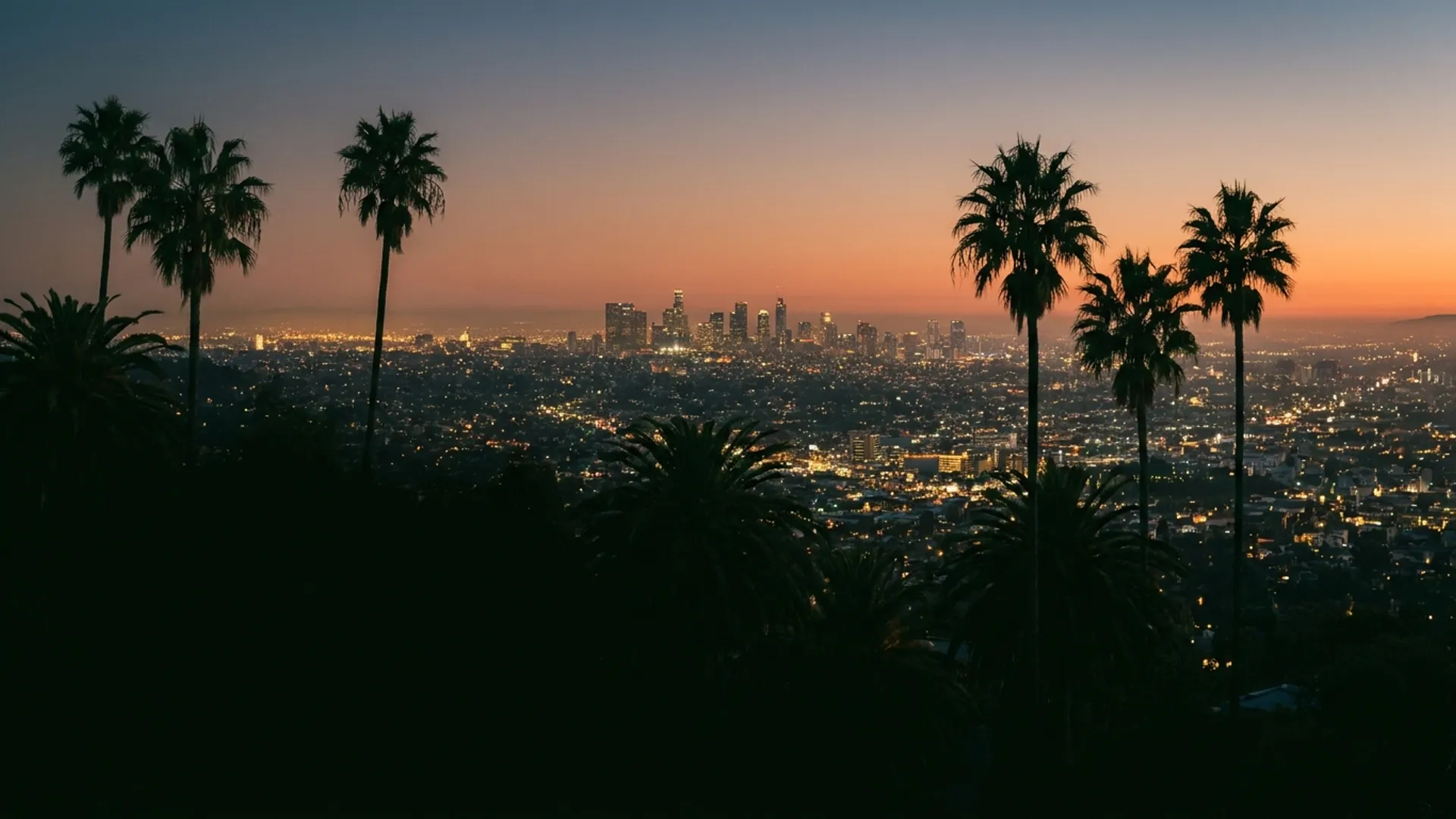 Cinematic view across the Los Angeles basin from the Beverly Hills foothills at dusk